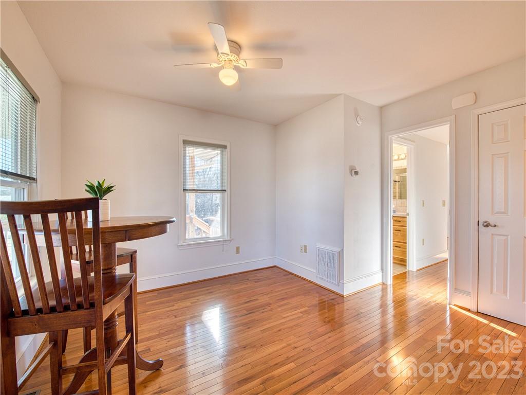 947 North Canton Road Canton, NC 28716 - Photo 13 of 24 an empty room with wooden floor and windows