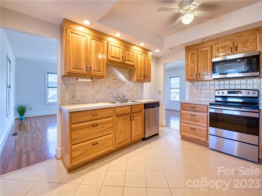 947 North Canton Road Canton, NC 28716 - Photo 14 of 24 a kitchen with stainless steel appliances a stove and more cabinets