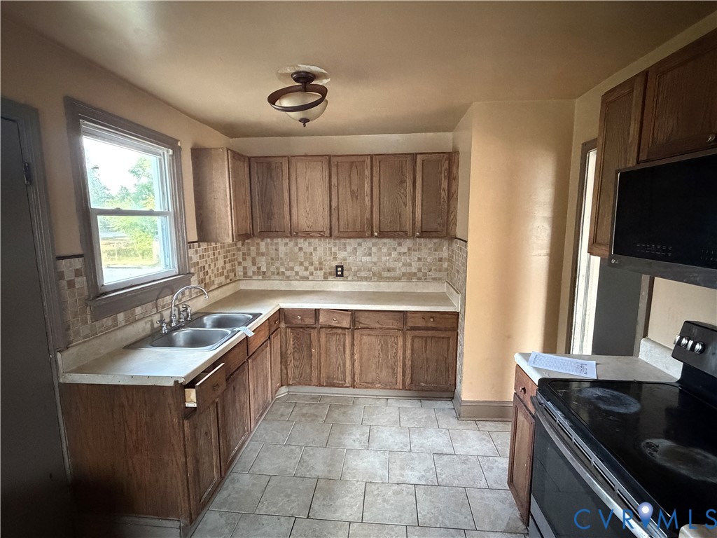 2401 Raleigh Street Hopewell, VA 23860 - Photo 2 of 10 a kitchen with a sink stove and cabinets