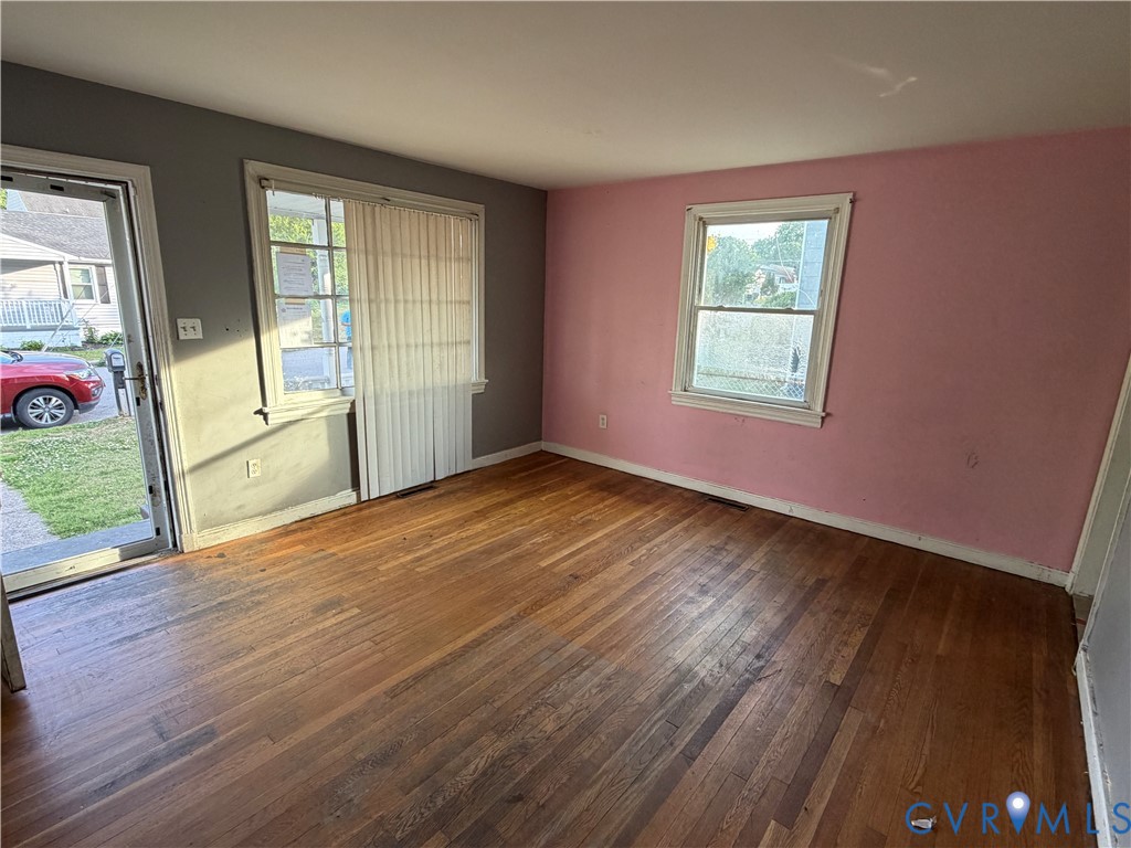 2401 Raleigh Street Hopewell, VA 23860 - Photo 4 of 10 a view of an empty room with wooden floor and a window
