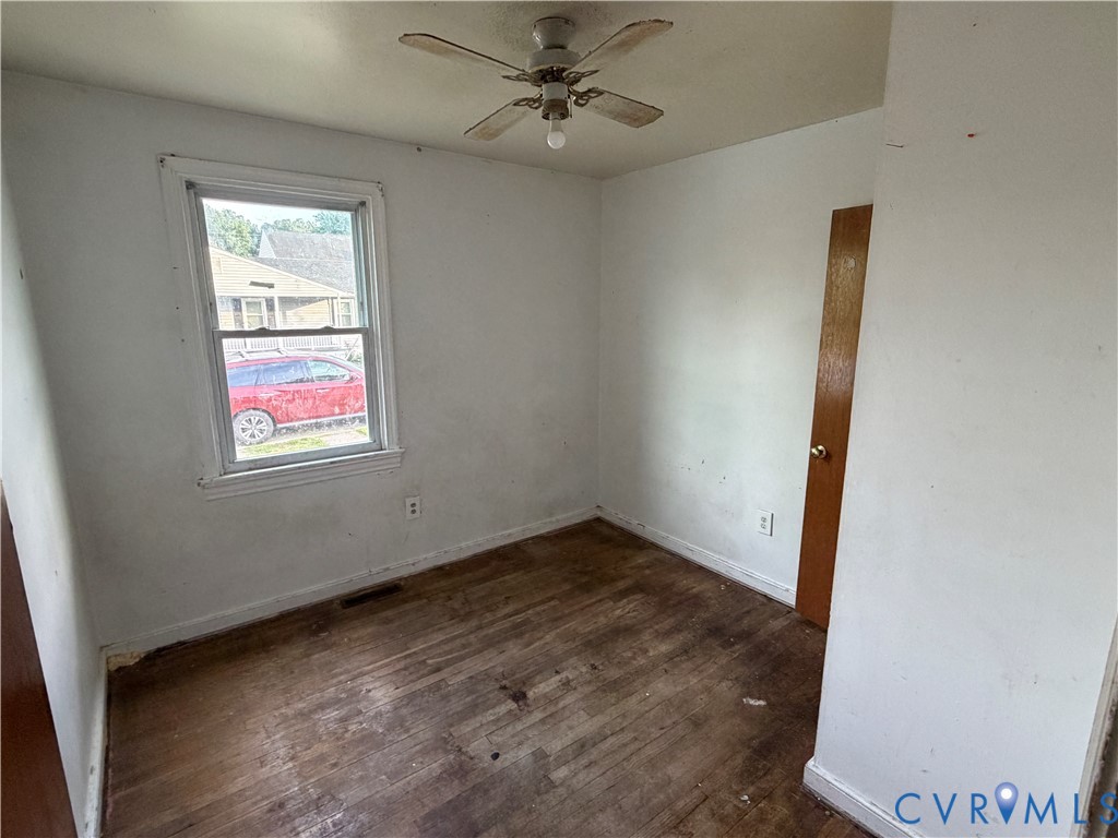 2401 Raleigh Street Hopewell, VA 23860 - Photo 7 of 10 an empty room with windows and fan