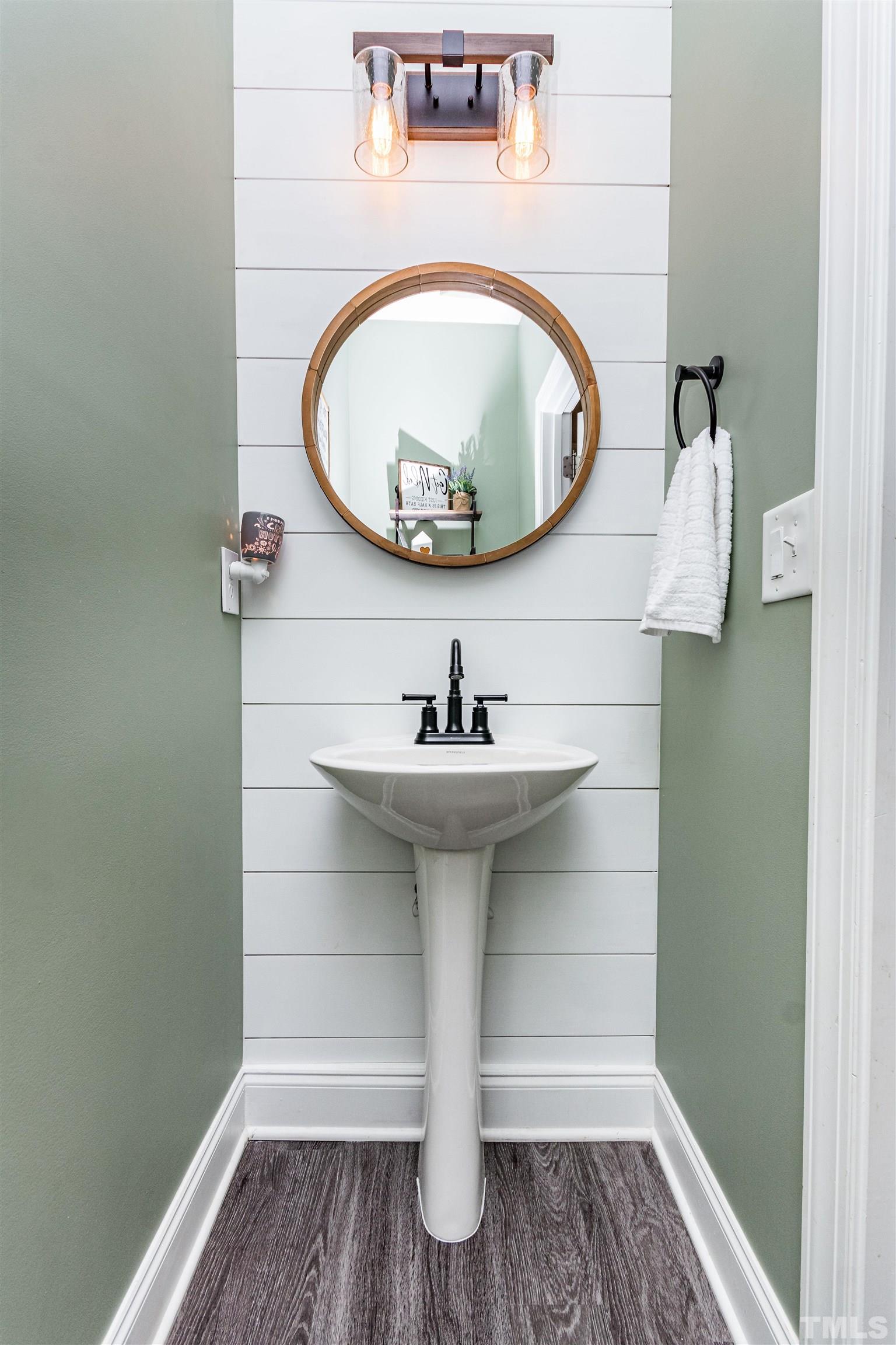 460 Mallard Loop Drive Clayton, NC 27527 - Photo 15 of 24 a bathroom with a sink and a mirror