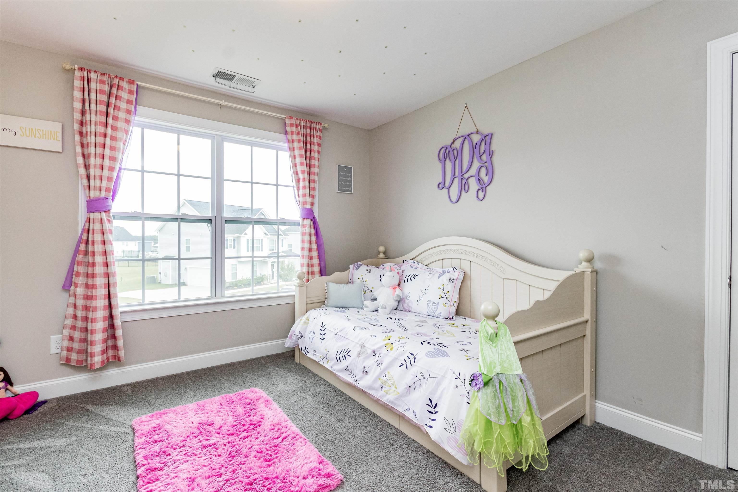 460 Mallard Loop Drive Clayton, NC 27527 - Photo 18 of 24 a bedroom with a bed and a window