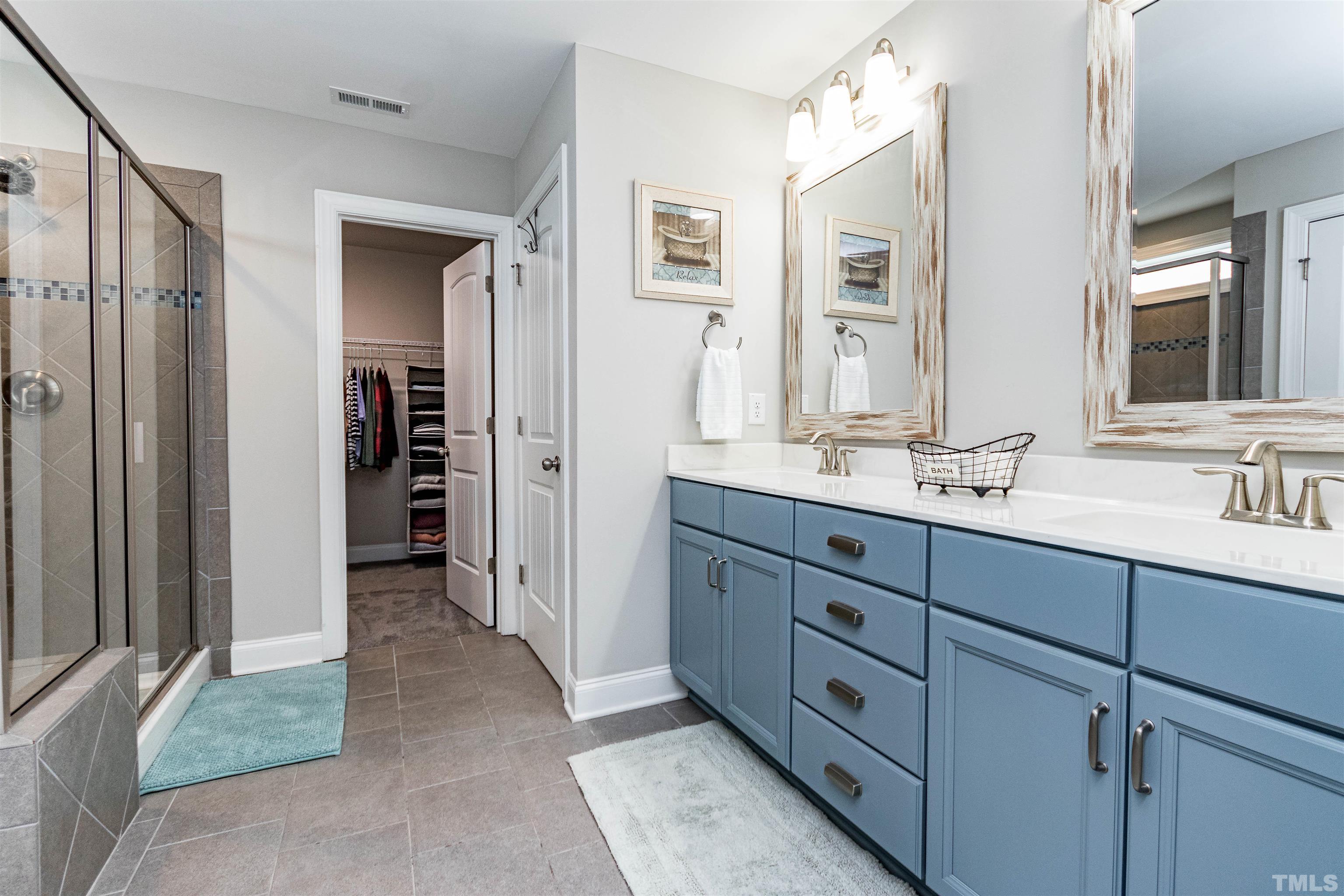 460 Mallard Loop Drive Clayton, NC 27527 - Photo 21 of 24 a spacious bathroom with a double vanity sink a mirror and a shower
