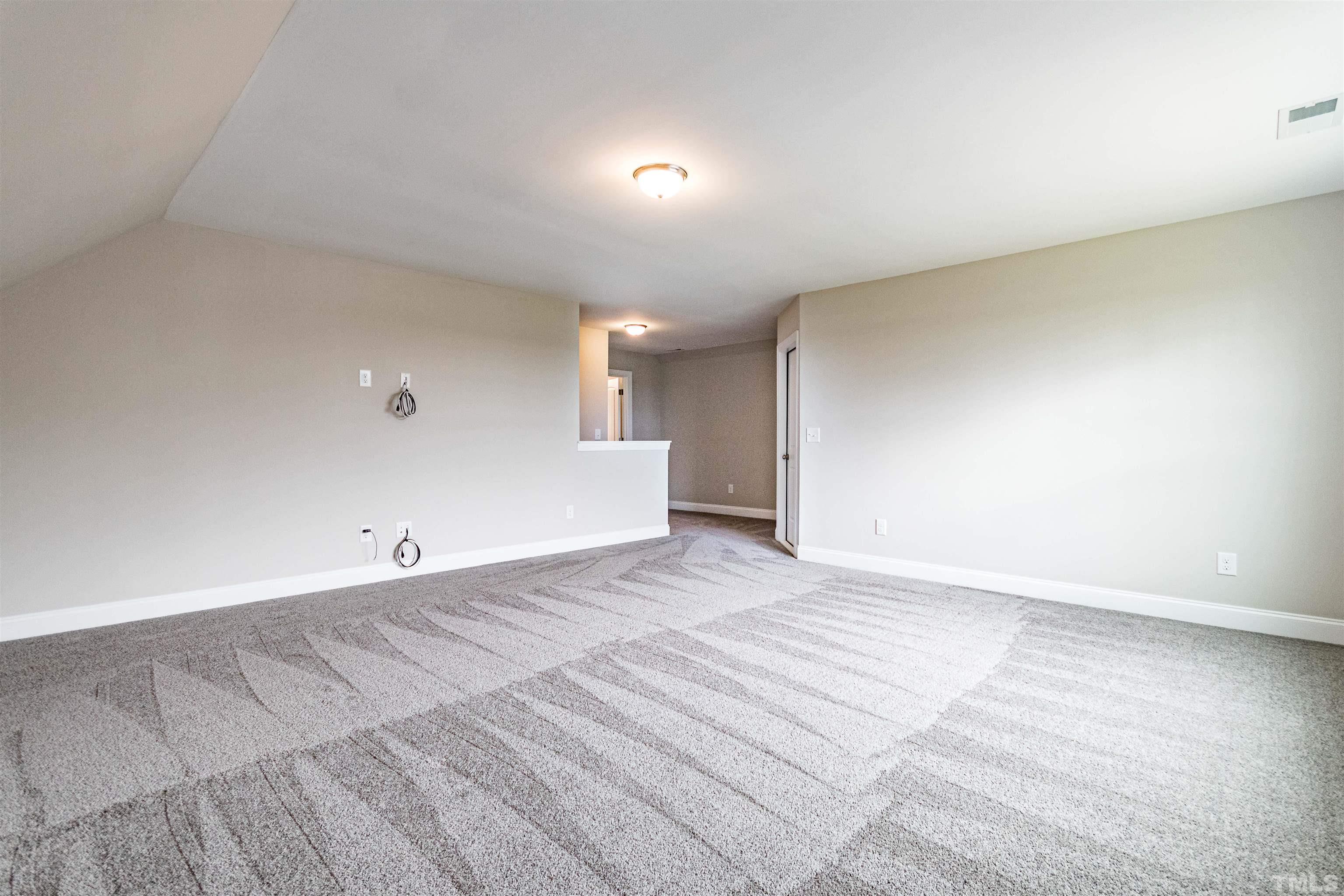 460 Mallard Loop Drive Clayton, NC 27527 - Photo 23 of 24 a view of an empty room with wooden floor and a window