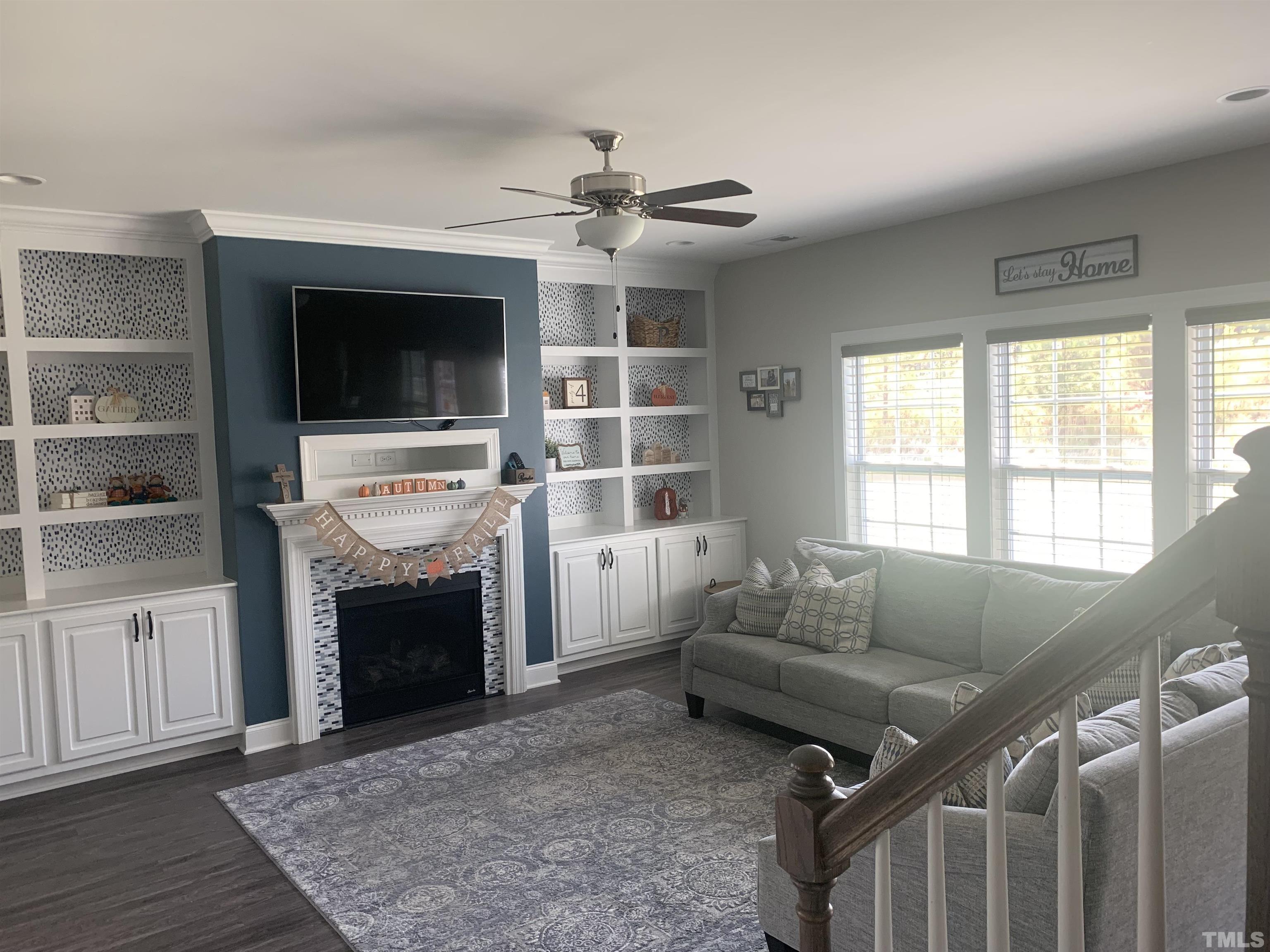 460 Mallard Loop Drive Clayton, NC 27527 - Photo 4 of 24 a living room with furniture a flat screen tv and a fireplace