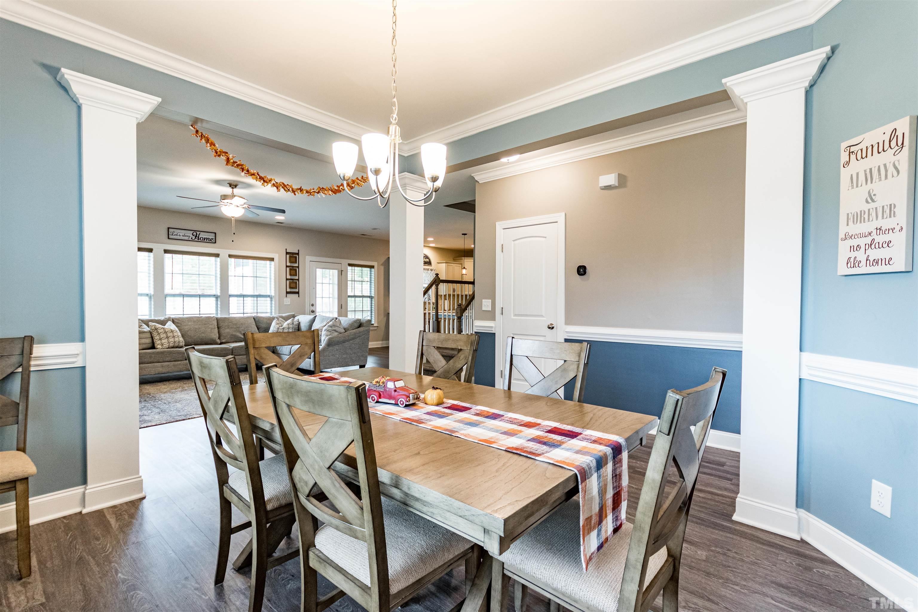 460 Mallard Loop Drive Clayton, NC 27527 - Photo 9 of 24 a view of a dining room with furniture wooden floor and chandelier