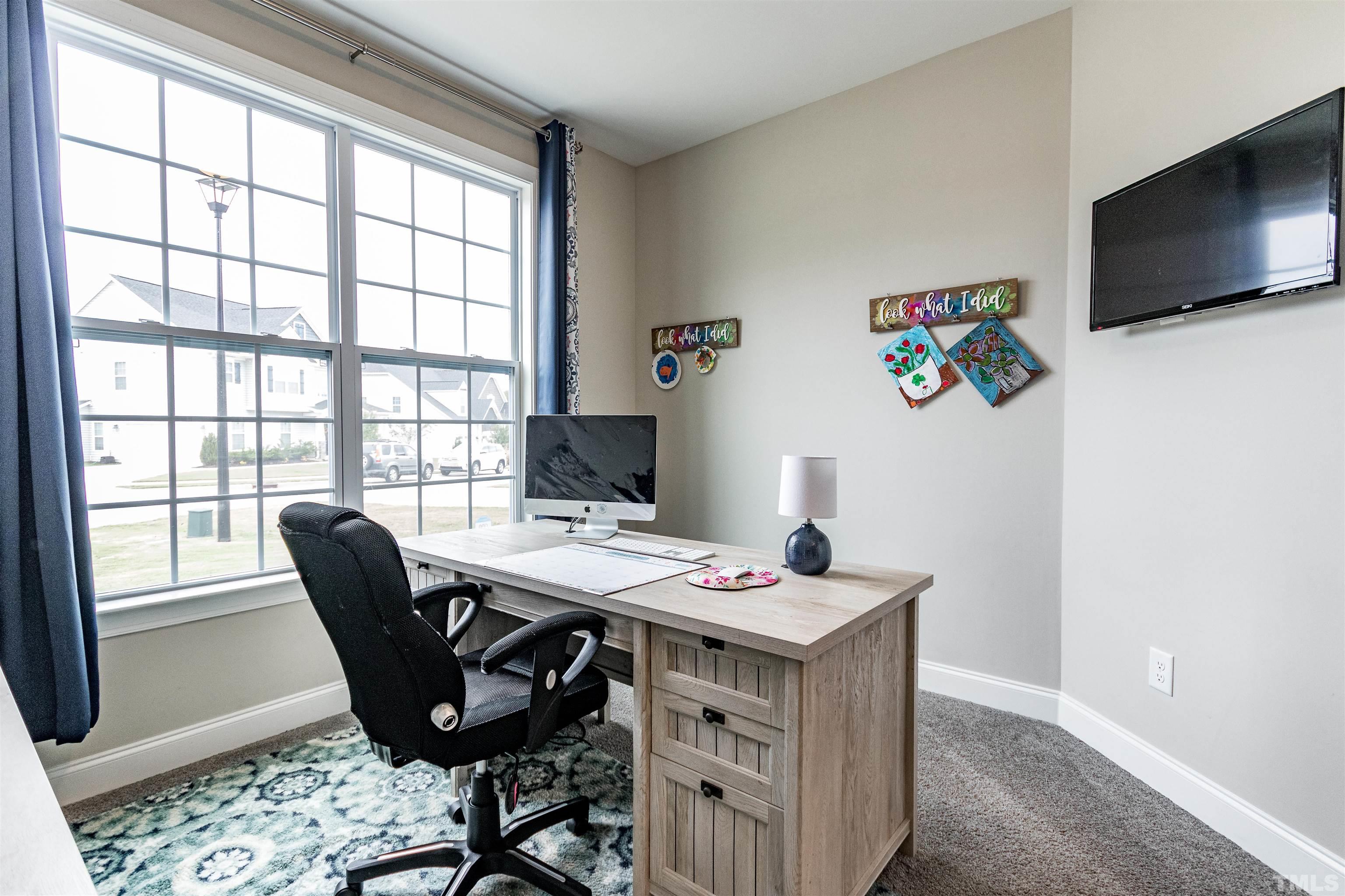460 Mallard Loop Drive Clayton, NC 27527 - Photo 10 of 24 a view of a workspace with furniture and a window
