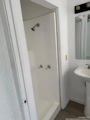 a bathroom with a sink and shower