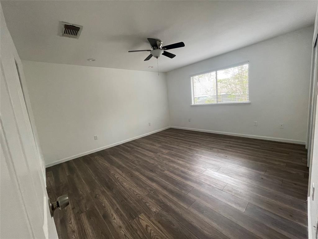 3 Ridge Drive Hickory Creek, TX 75065 - Photo 15 of 20 an empty room with wooden floor ceiling fan and windows