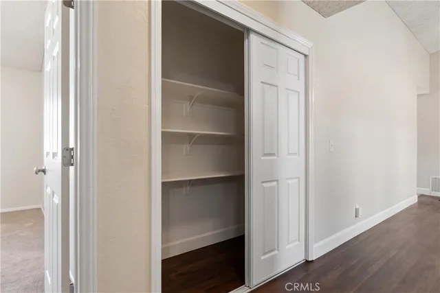 a view of walk in closet with empty racks