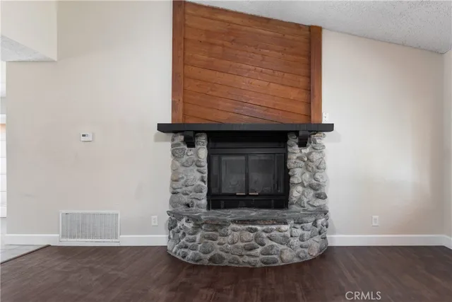 a room with wooden floor and a fireplace
