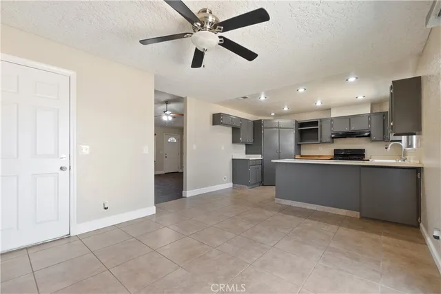 a view of kitchen with refrigerator and microwave