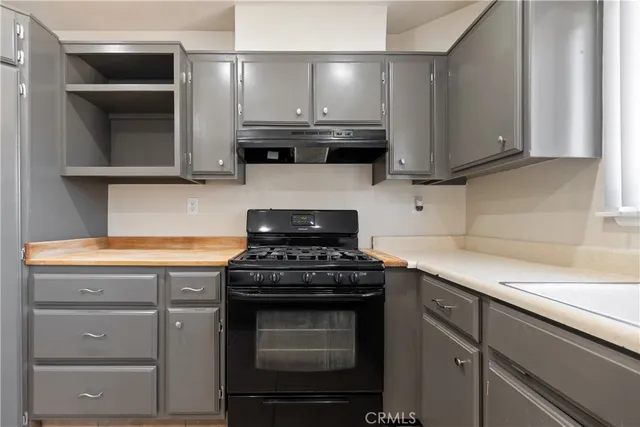 a kitchen with granite countertop a stove and a sink