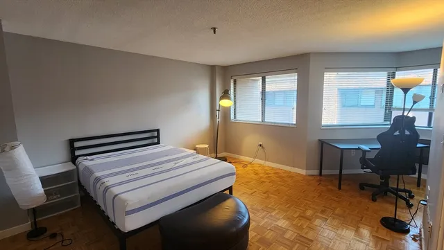 a bedroom with a bed and a chair