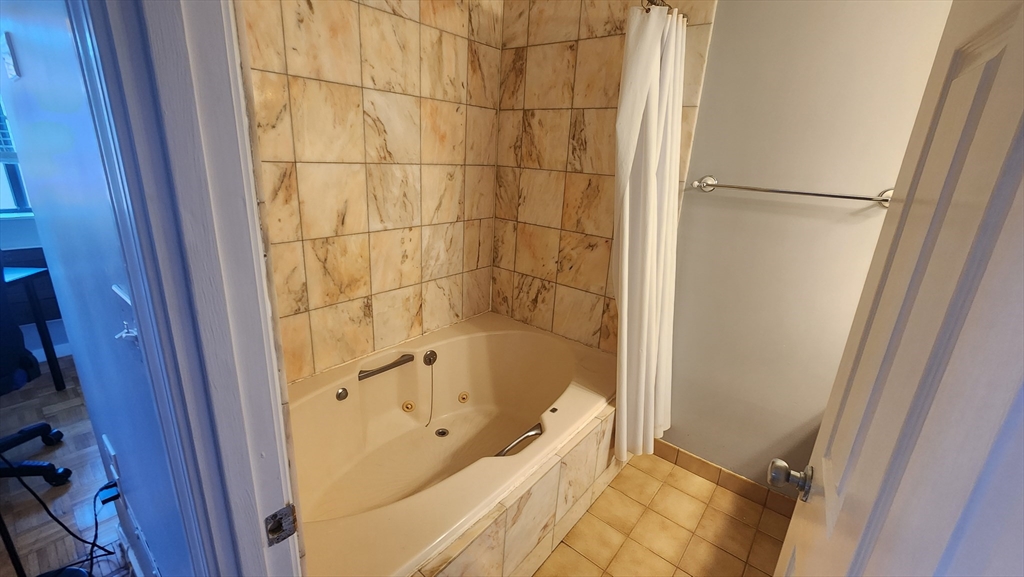 147 Kelton Street, Unit 706 Boston, MA 02134 - Photo 13 of 16 a bathroom with a bathtub