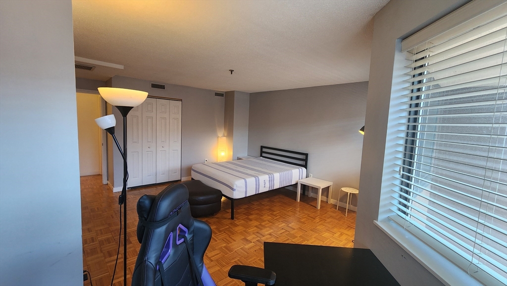 147 Kelton Street, Unit 706 Boston, MA 02134 - Photo 15 of 16 a view of a room with furniture and wooden floor