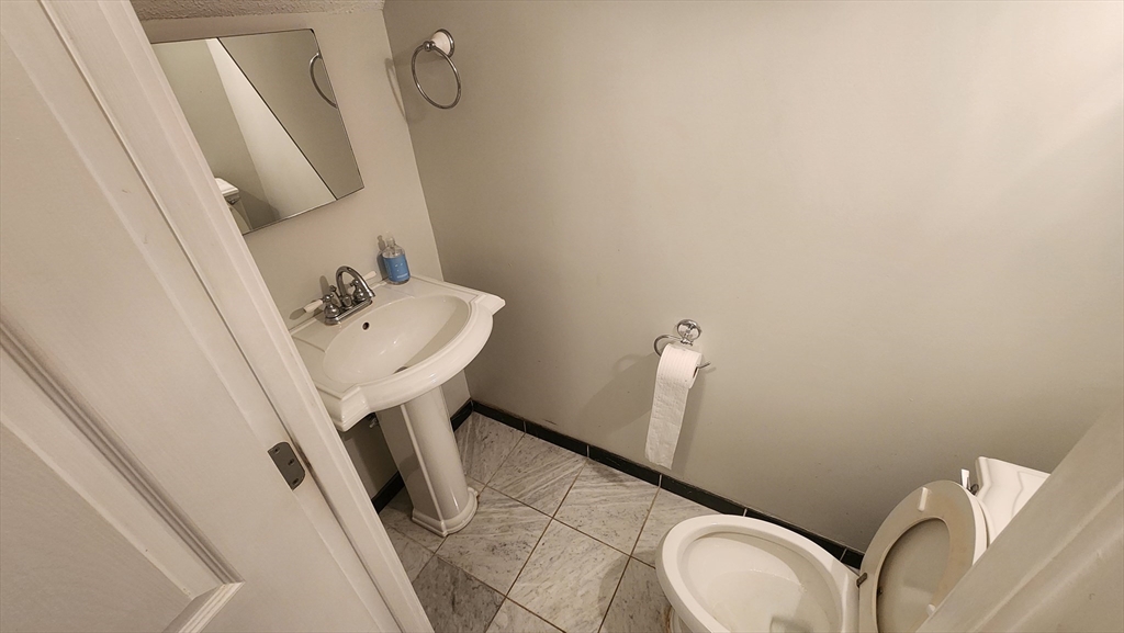 147 Kelton Street, Unit 706 Boston, MA 02134 - Photo 3 of 16 a bathroom with a sink a toilet and mirror