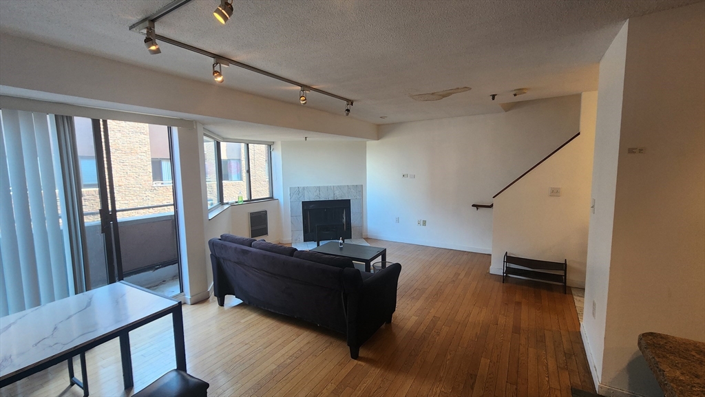 147 Kelton Street, Unit 706 Boston, MA 02134 - Photo 7 of 16 a living room with furniture and a wooden floor