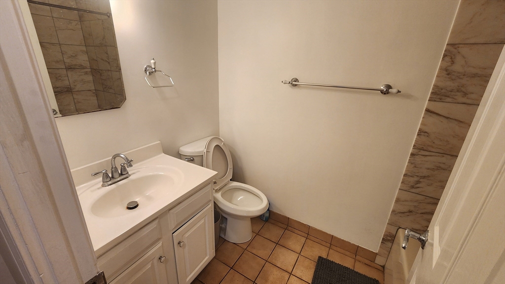 147 Kelton Street, Unit 706 Boston, MA 02134 - Photo 9 of 16 a bathroom with a sink toilet and shower