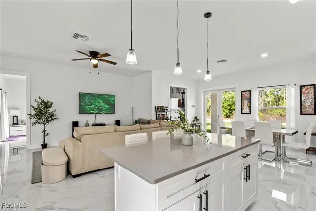 a large kitchen with a table and chairs