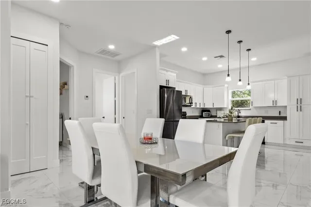 a view of a dining room with furniture and window