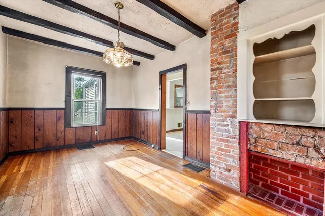 a view of an entryway with wooden floor