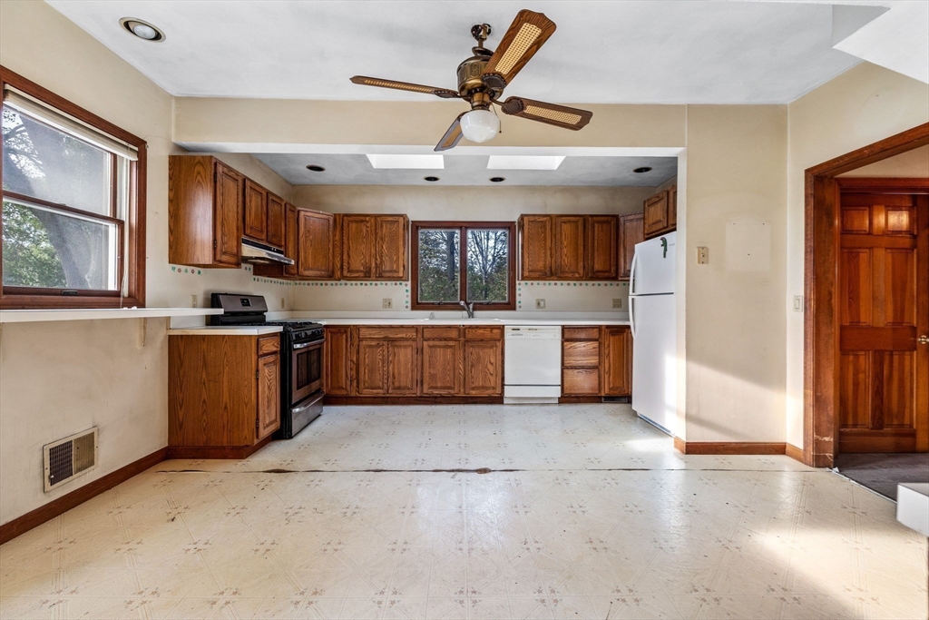 16 2nd Street Saugus, MA 01906 - Photo 14 of 37 a kitchen with stainless steel appliances granite countertop a stove sink and cabinets