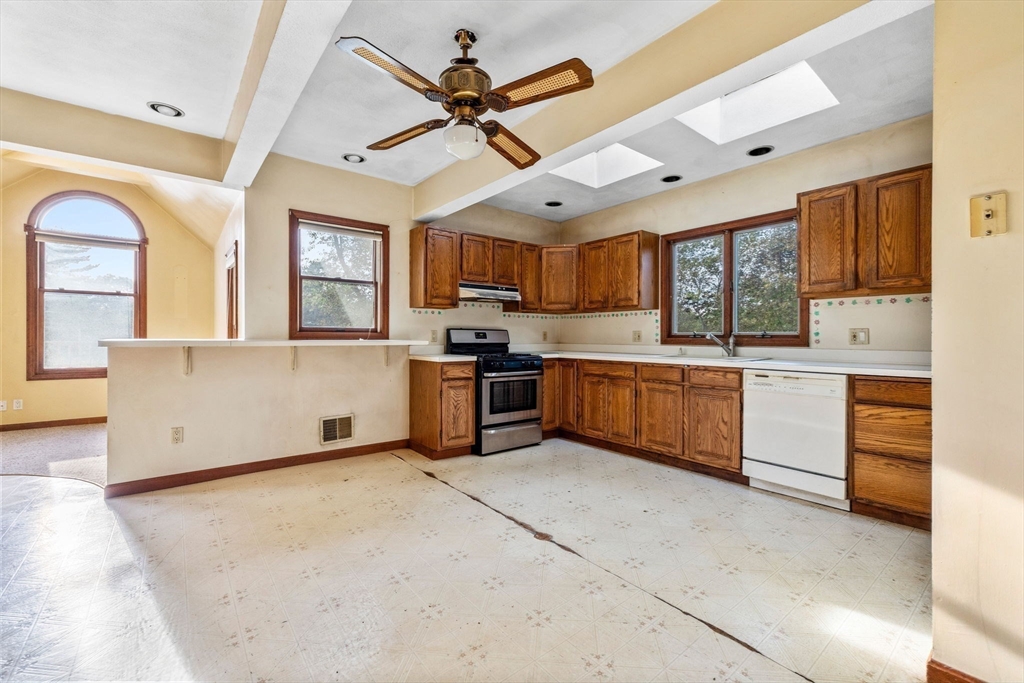 16 2nd Street Saugus, MA 01906 - Photo 16 of 37 a kitchen with cabinets a window and stainless steel appliances