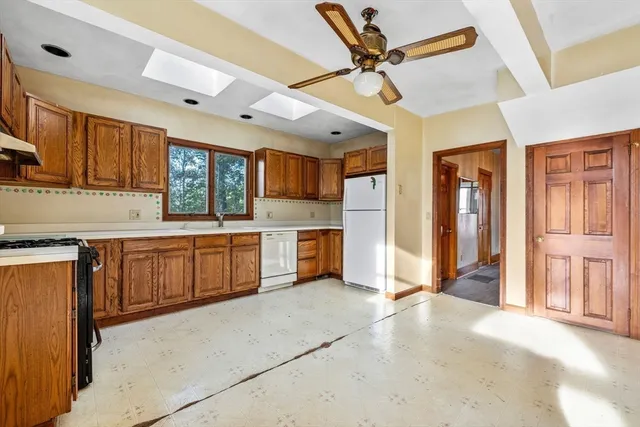 a kitchen with a refrigerator a sink and cabinets