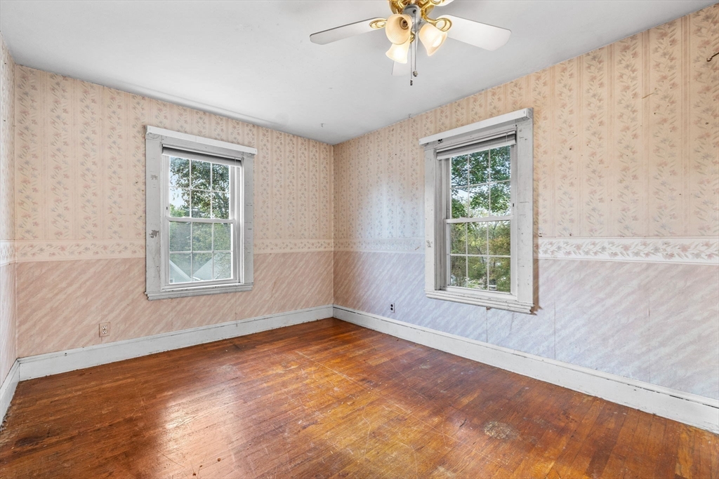 16 2nd Street Saugus, MA 01906 - Photo 22 of 37 a view of an empty room with a window and wooden floor