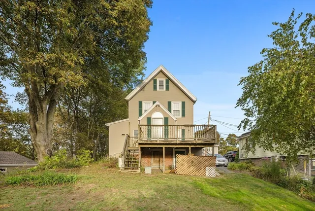 a view of a house with a large trees in front of it