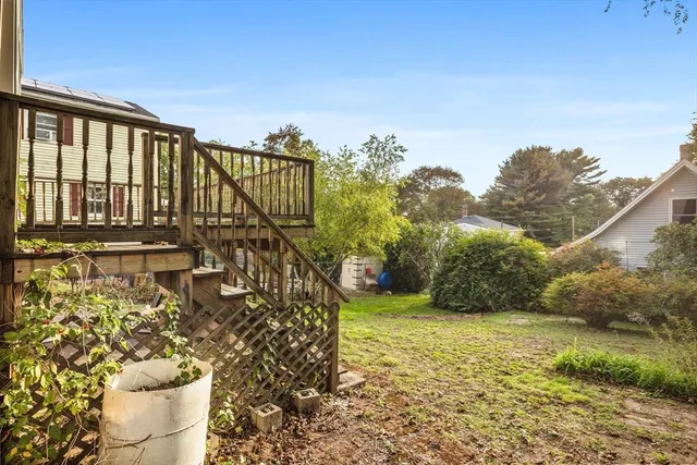 a view of a pathway of a house with a yard
