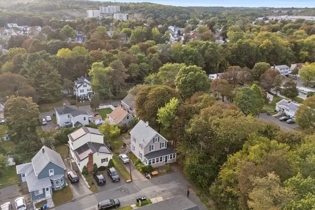 an aerial view of residential house with outdoor space and trees