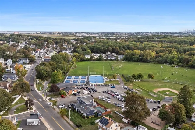an aerial view of a city with a lake view