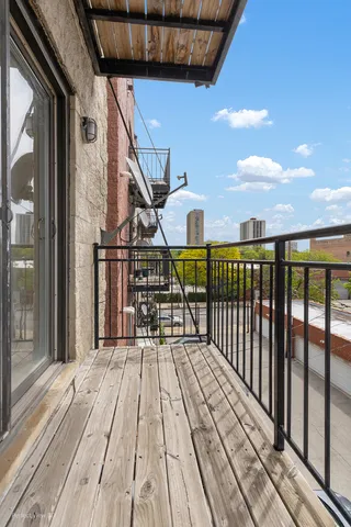 a view of balcony with wooden floor and fence
