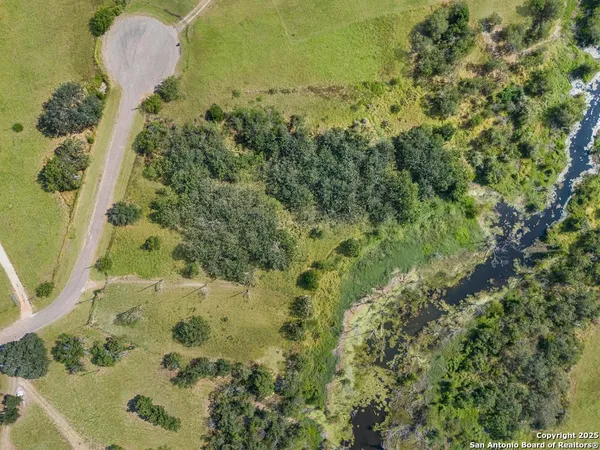 an aerial view of a house with a yard