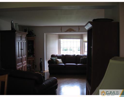 77 Princess Drive North Brunswick, NJ 08902 - Photo 5 of 7 a living room with furniture and a flat screen tv