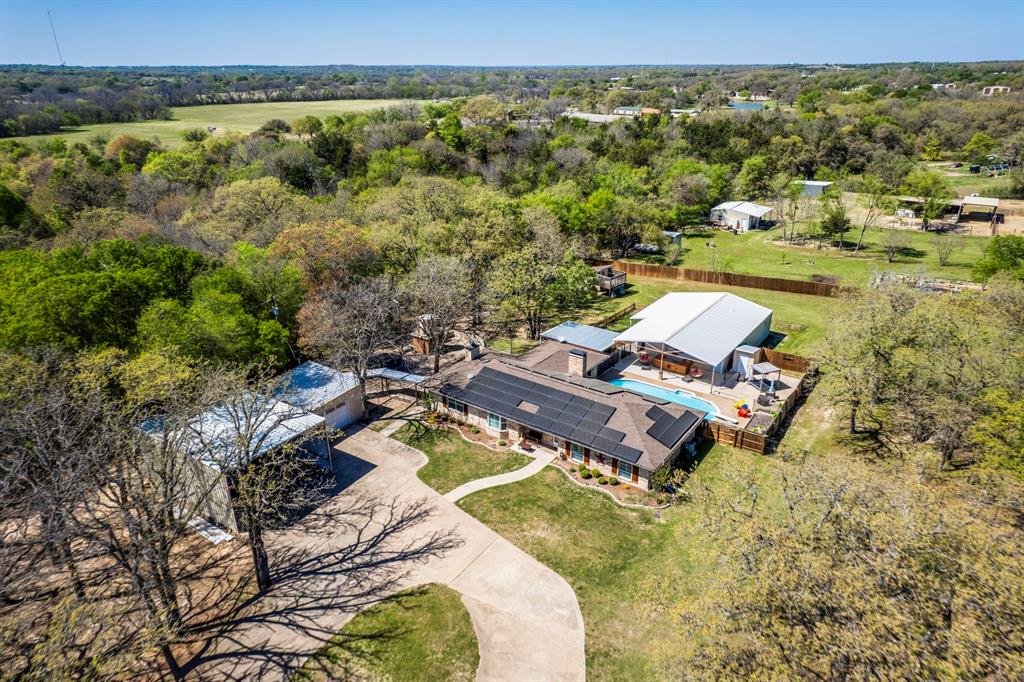 an aerial view of a house with a yard
