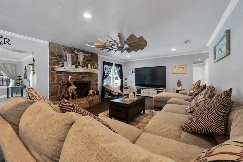 2263 Old Dicey Road Weatherford, TX 76085 - Photo 11 of 40 a living room with furniture a fireplace and a flat screen tv