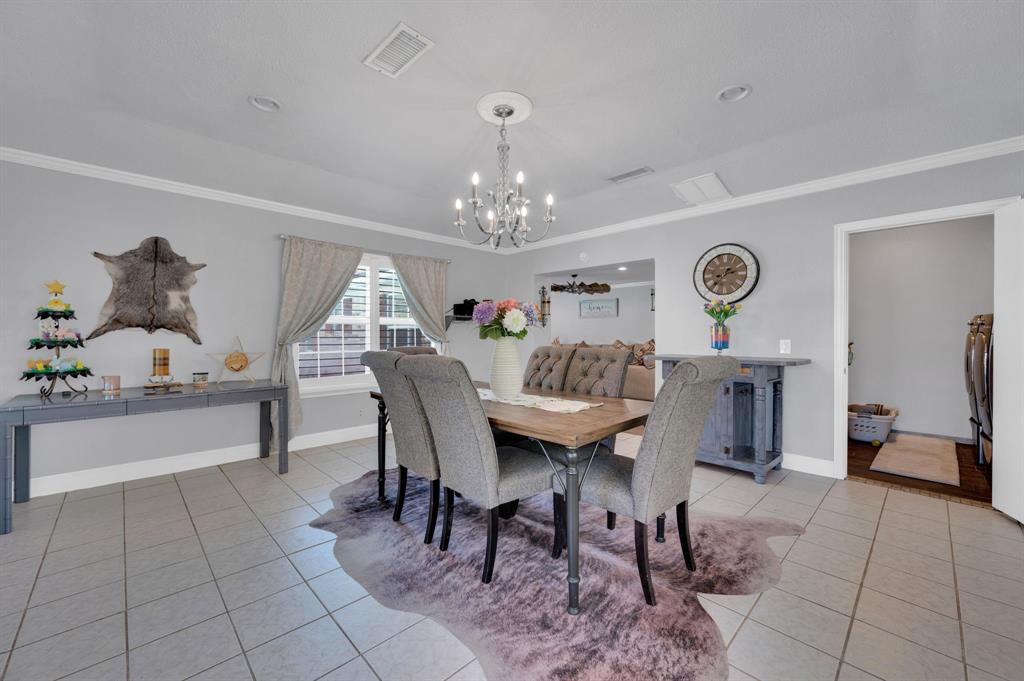 2263 Old Dicey Road Weatherford, TX 76085 - Photo 12 of 40 a view of a dining room with furniture and chandelier