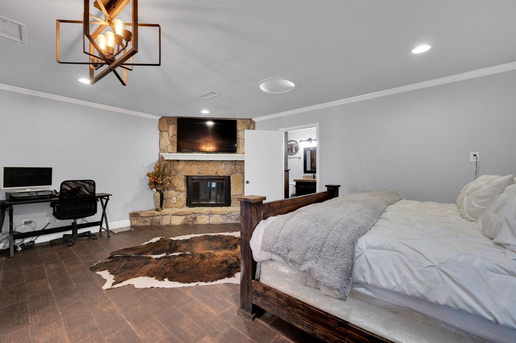 2263 Old Dicey Road Weatherford, TX 76085 - Photo 14 of 40 a bedroom with a bed and a flat screen tv