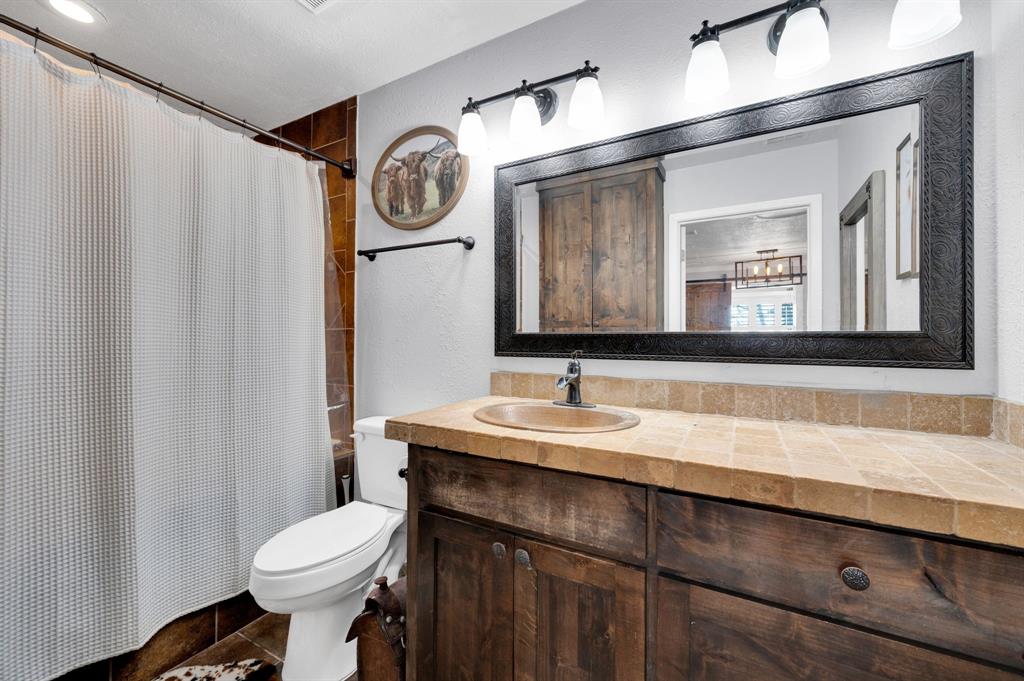 2263 Old Dicey Road Weatherford, TX 76085 - Photo 15 of 40 a bathroom with a sink and a mirror