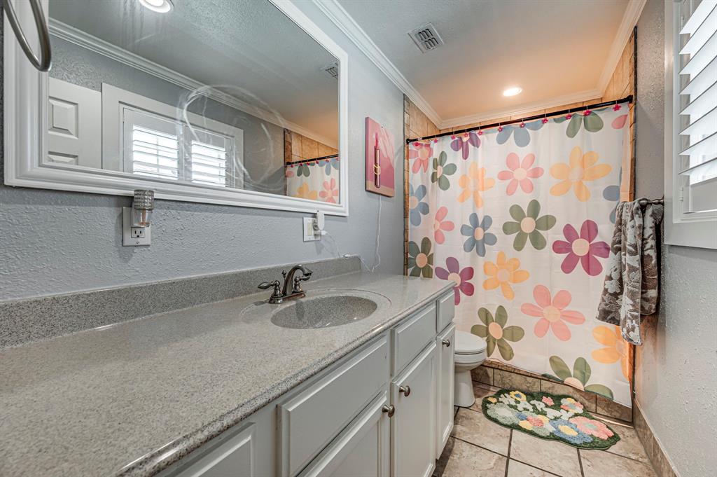 2263 Old Dicey Road Weatherford, TX 76085 - Photo 17 of 40 a bathroom with a sink mirror vanity and a shower