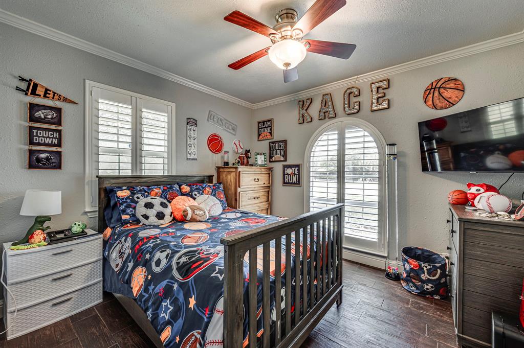 2263 Old Dicey Road Weatherford, TX 76085 - Photo 18 of 40 a bedroom with bed and a chandelier