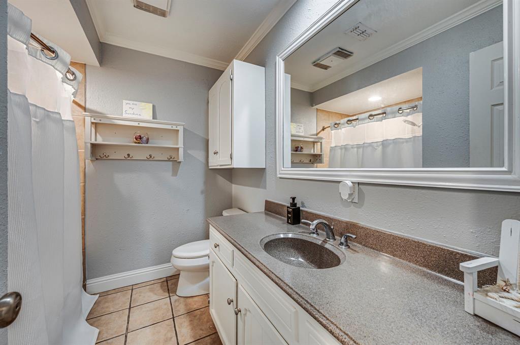2263 Old Dicey Road Weatherford, TX 76085 - Photo 20 of 40 a bathroom with a sink a toilet and a mirror