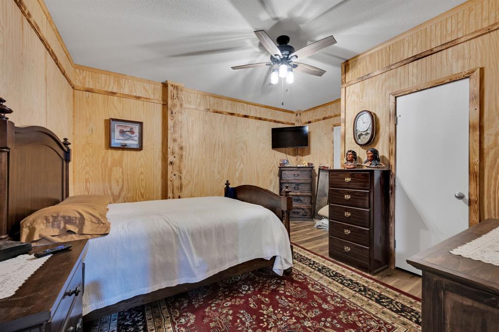 2263 Old Dicey Road Weatherford, TX 76085 - Photo 33 of 40 a bedroom with a bed and a chandelier