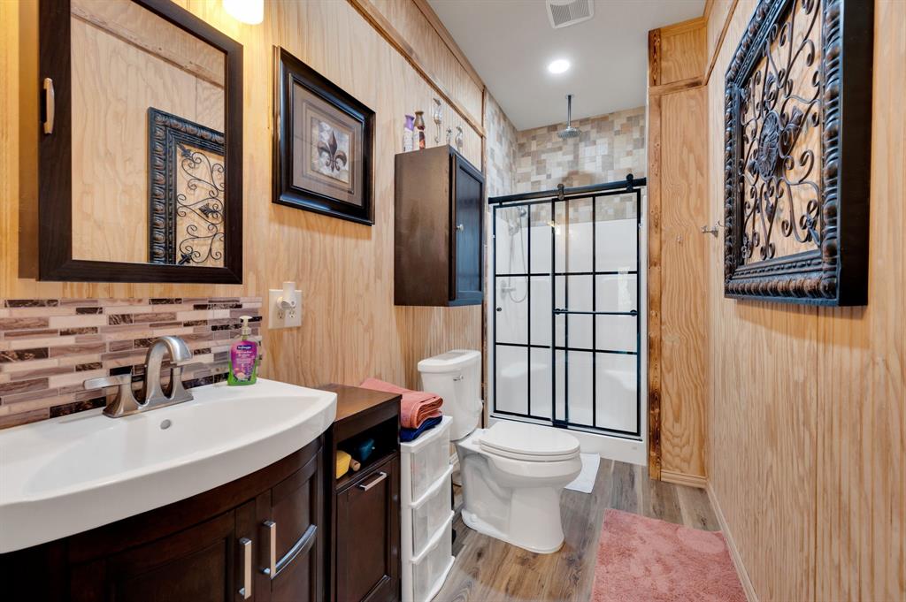 2263 Old Dicey Road Weatherford, TX 76085 - Photo 34 of 40 a bathroom with a sink toilet vanity and shower