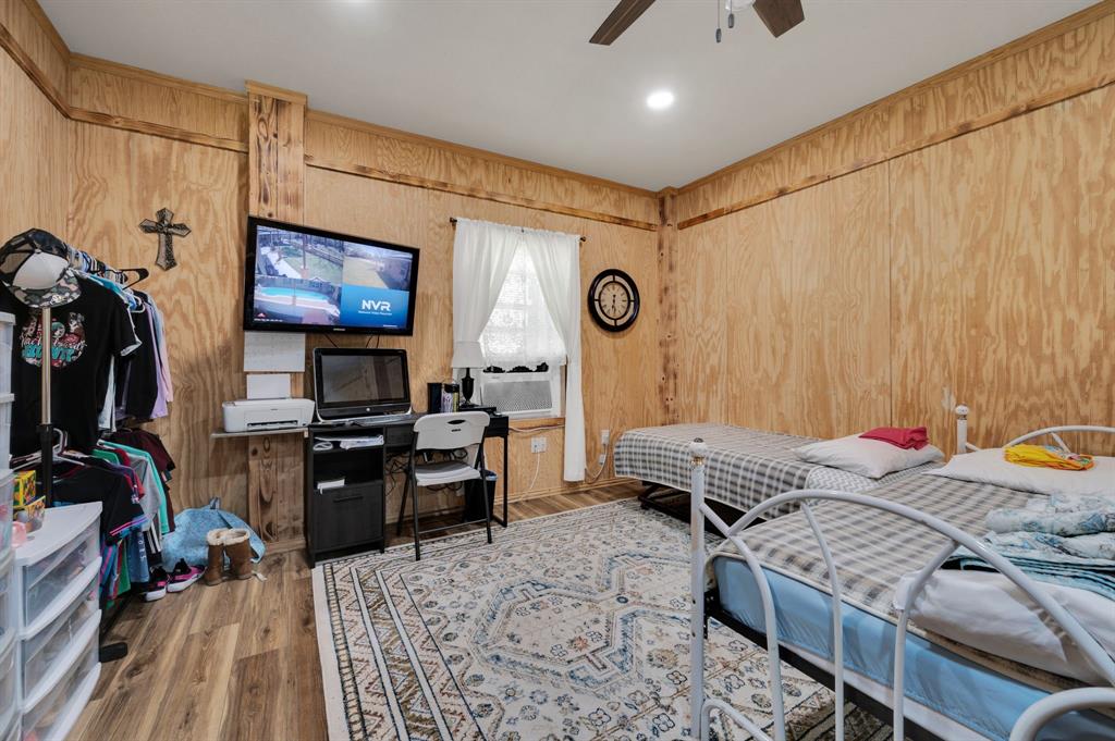 2263 Old Dicey Road Weatherford, TX 76085 - Photo 35 of 40 a bedroom with a bed and a flat screen tv