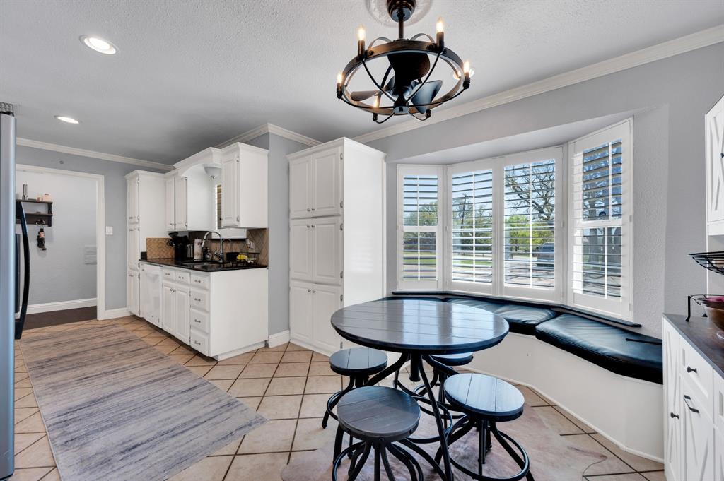 2263 Old Dicey Road Weatherford, TX 76085 - Photo 4 of 40 a kitchen with stainless steel appliances a dining table chairs and sink